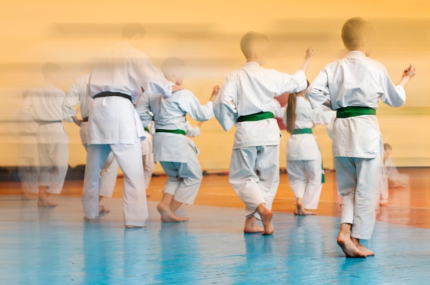 Martial arts art Colored background with elements of movement and blur on the topic of children in karate Without faces For web design and printing