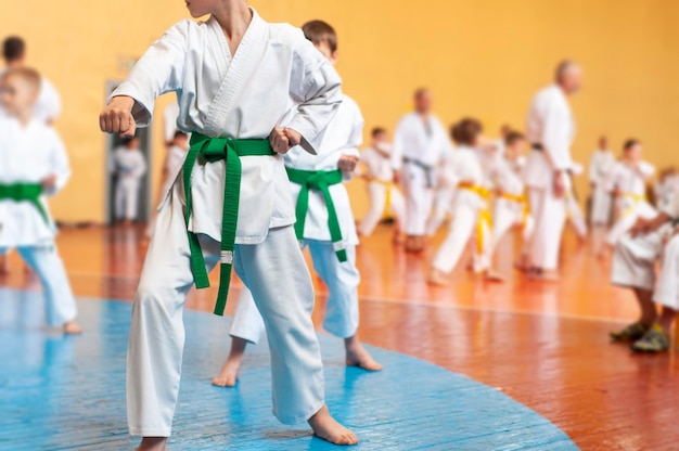 Martial arts art colored background with elements of movement\
and blur on the topic of children in karate without faces for web\
design and printing