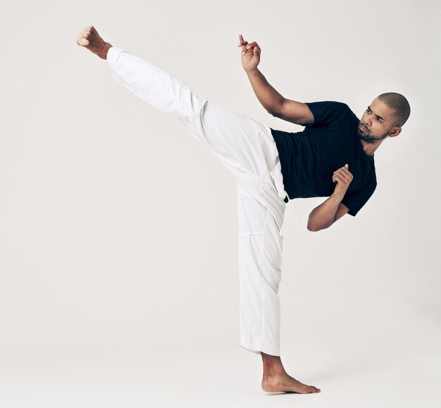martial arts karate and man with training wellness and self defense on white studio background healthy person fighter and model with practice and conflict with sports and competition with workout