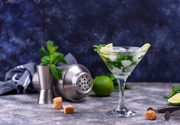 Martini cocktail with lime and mint.