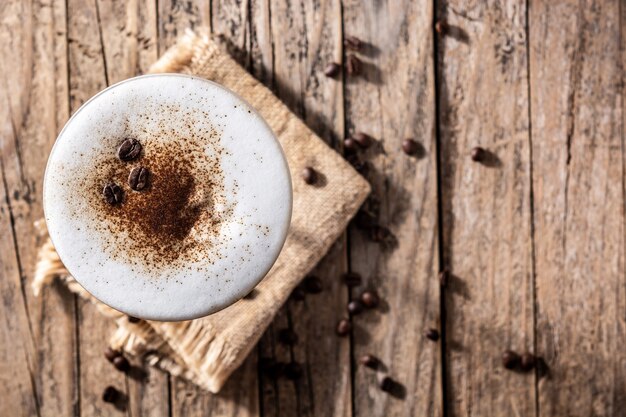 Martini espresso cocktail in glass on wooden table