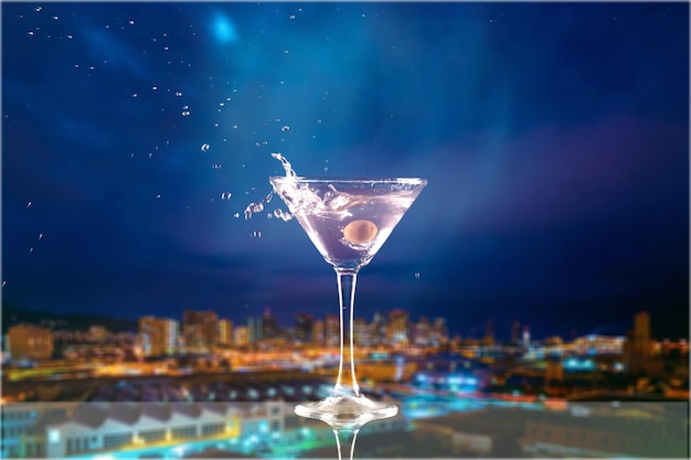 Martini in glass with olives on blurred background