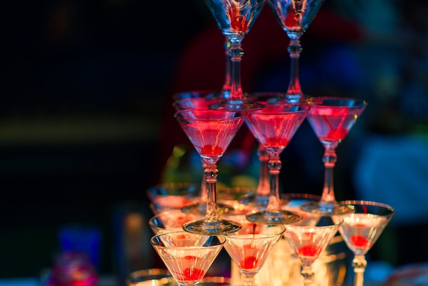 Martini glasses with cherries with red bright illumination