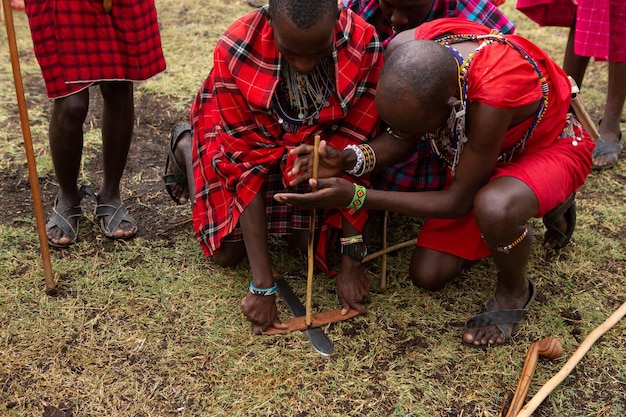 Masai in traditional colorful clothing showing Maasai jumping dance at local tribe village