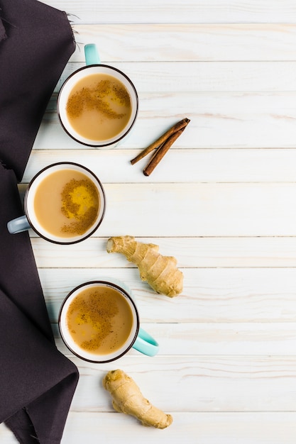 Masala tea in ceramic cups with the winter spices of cinnamon and ginger 