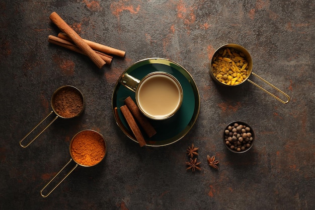 Masala tea and spices on dark gray background top view