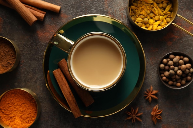 Photo masala tea and spices on dark gray background top view