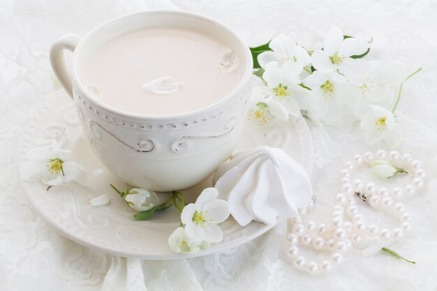 Masala thee chai latte zelfgemaakte traditionele Indiase zoete melk met kruiden drank in porseleinen kopje op houten tafel muur