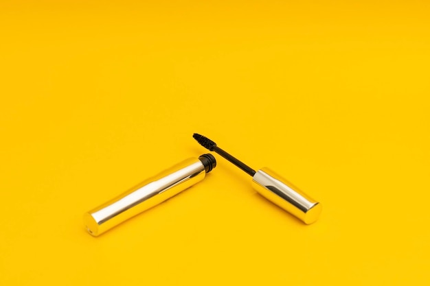 Mascara in silver package with yellow background