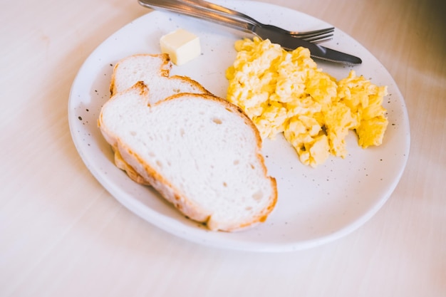 Mascarpone Scrambled Eggs with Garlic Toasts food breakfast meal in ceramic plate disk