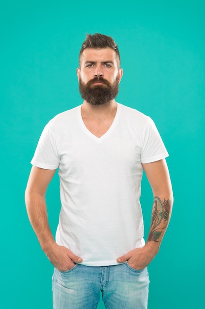 Masculine and brave Beard fashion and barber concept Man bearded hipster stylish beard turquoise background Barber tips maintain beard Stylish beard and mustache care Hipster appearance