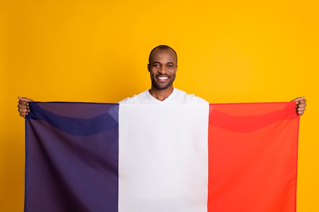 Masculine football fan african guy hold french national\
flag