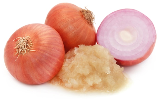 Mashed onion with whole ones over white background
