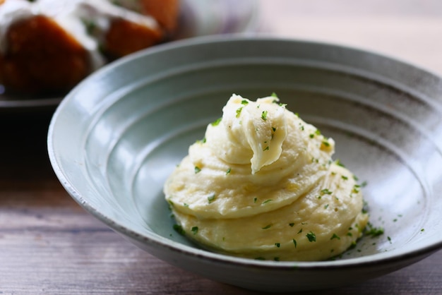 Mashed potatoes in bowl on wooden rustic table