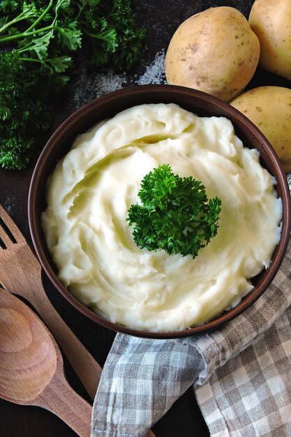 Mashed potatoes with herbs in a bowl. Flat lay.