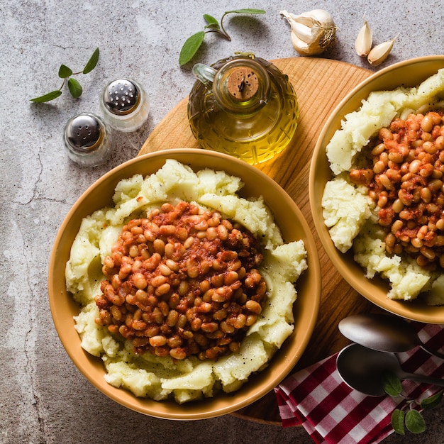 Mashed potatoes with stewed white beans in tomatoes