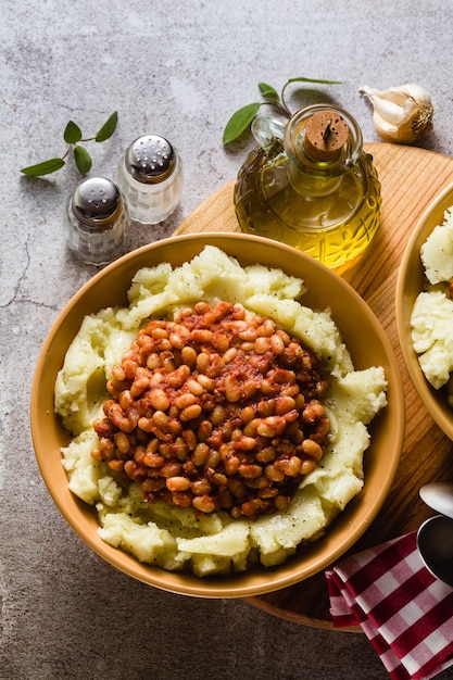 Mashed potatoes with stewed white beans in tomatoes