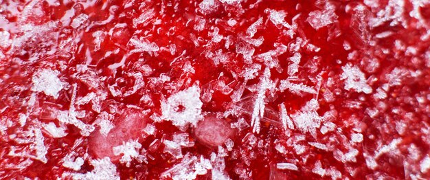 Mashed red fresh frozen strawberries background closeup banner