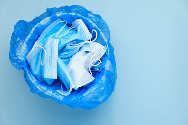 Mask thrown in the trash. Discarded surgical masks.