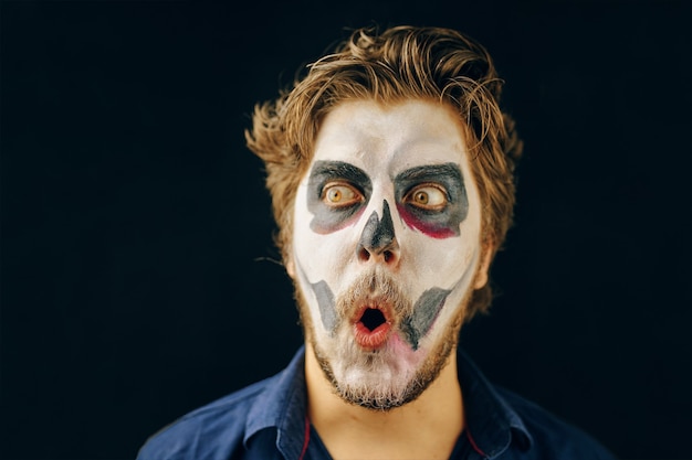 Masked man of the day of death on halloween surprised look