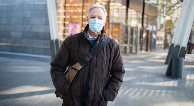 Masked man walking outdoor to go at work coronavirus people lifestyle concept