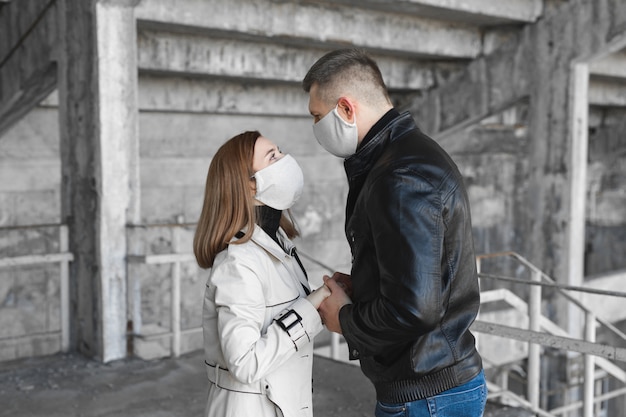 Masked man and woman embrace