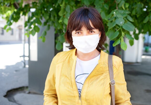 Masked woman posing outdoors during coronavirus pandemic