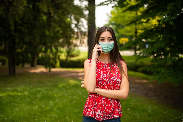 Masked woman talking on the phone