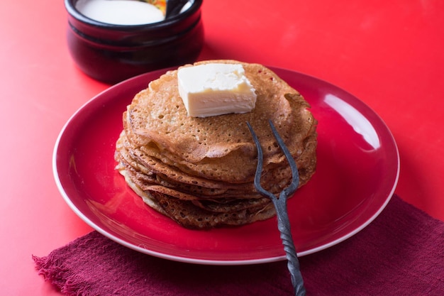 Maslenitsa holiday pancakes with sour cream on the table The Russian tradition