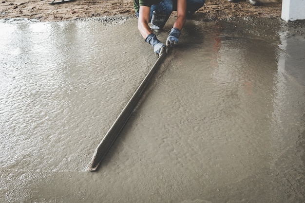 Mason building a screed coat cement