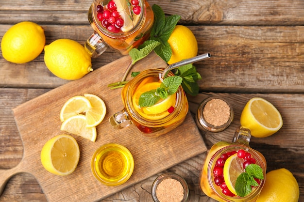 Mason jars of cold tea on wooden table