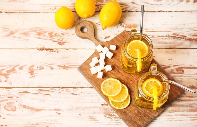 Mason jars of cold tea on wooden table