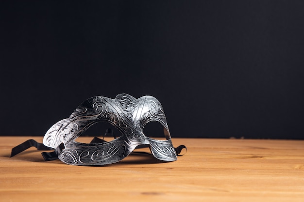 Masquerade mask on a wooden table background