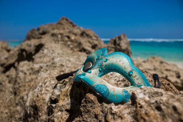 Masquerade party mask on beach view