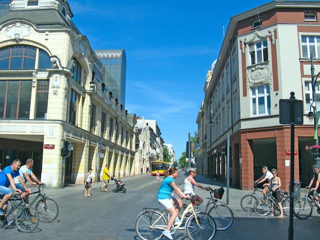 Mass tourism is not biking Tourists ride around the city on bicycles rented People ride bicycles in the Polish city of Lodz