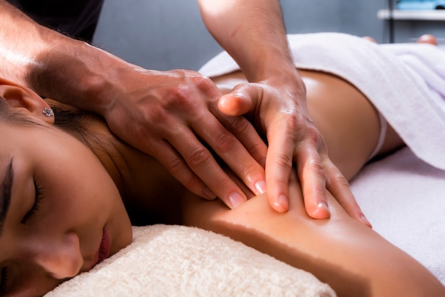 Photo massage is a beautiful photo. a beautiful woman lies in the massage therapist's office. photos of spa treatments.