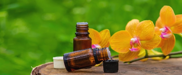 Massage oil and stones with yellow orchid