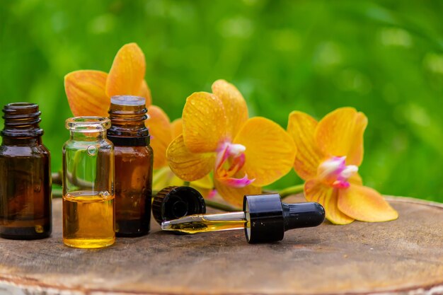 Massage oil and stones with yellow orchid