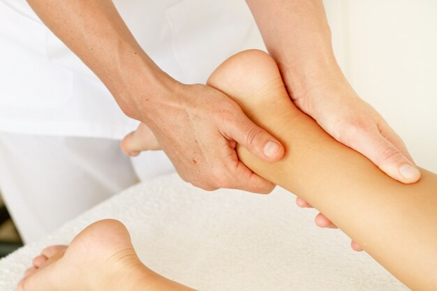 Massage and physiotherapy to a woman on her feet