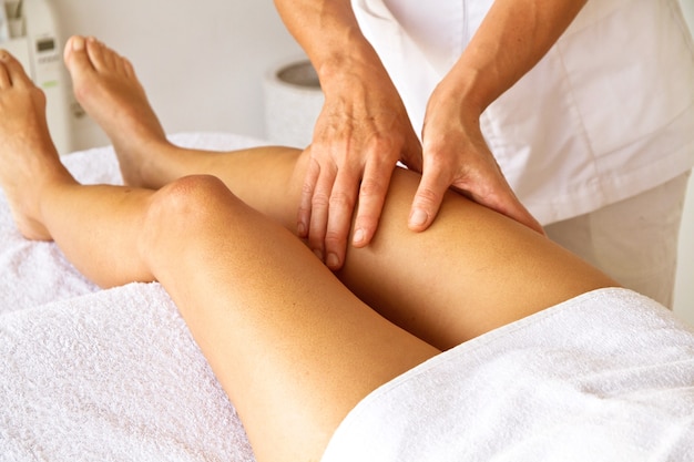 Massage and physiotherapy to a woman on her legs