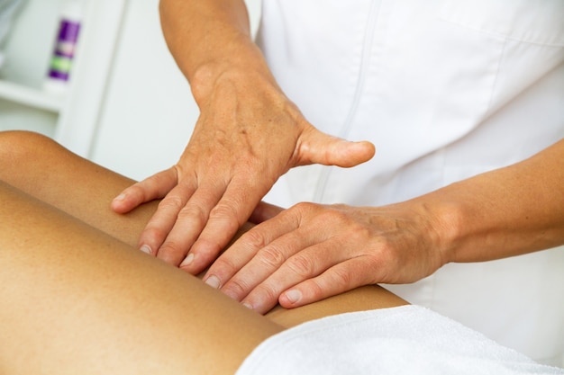 Massage and physiotherapy to a woman on her legs