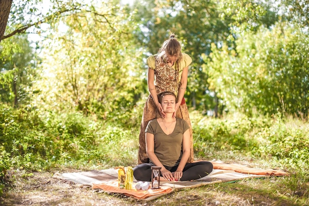 Massage professional demonstrates refreshing massaging methods in the sunlight.