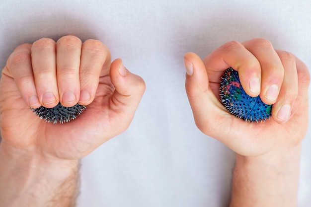 Massage rubber balls in hands.