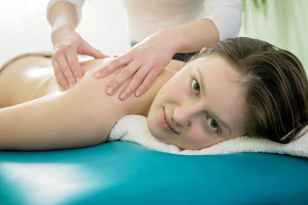 Massage on the shoulder of a young girl