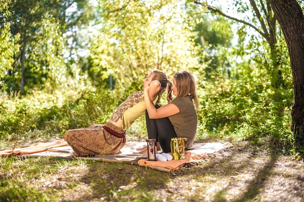 Massage therapist applies her massage skills on her client in the daylight.