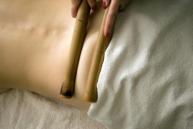 Massage with bamboo sticks