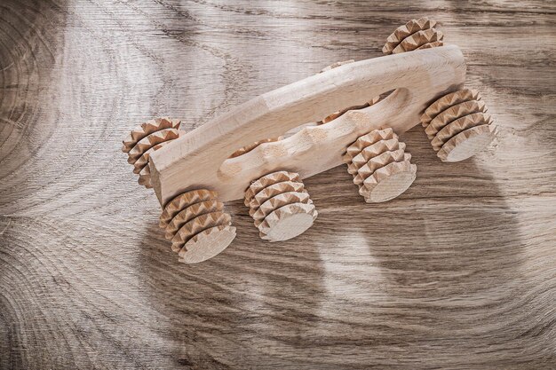 Photo massager on wooden board top view healthcare concept