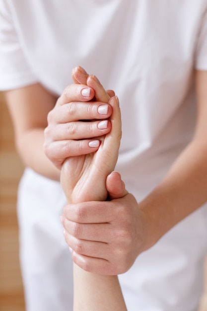 Masseur does hand massage