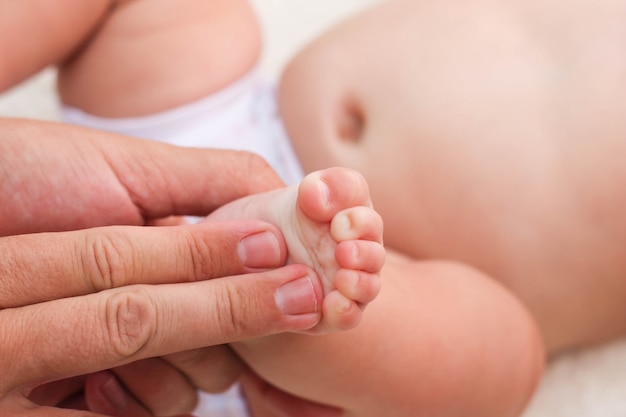 masseur doing massage for foot little baby 