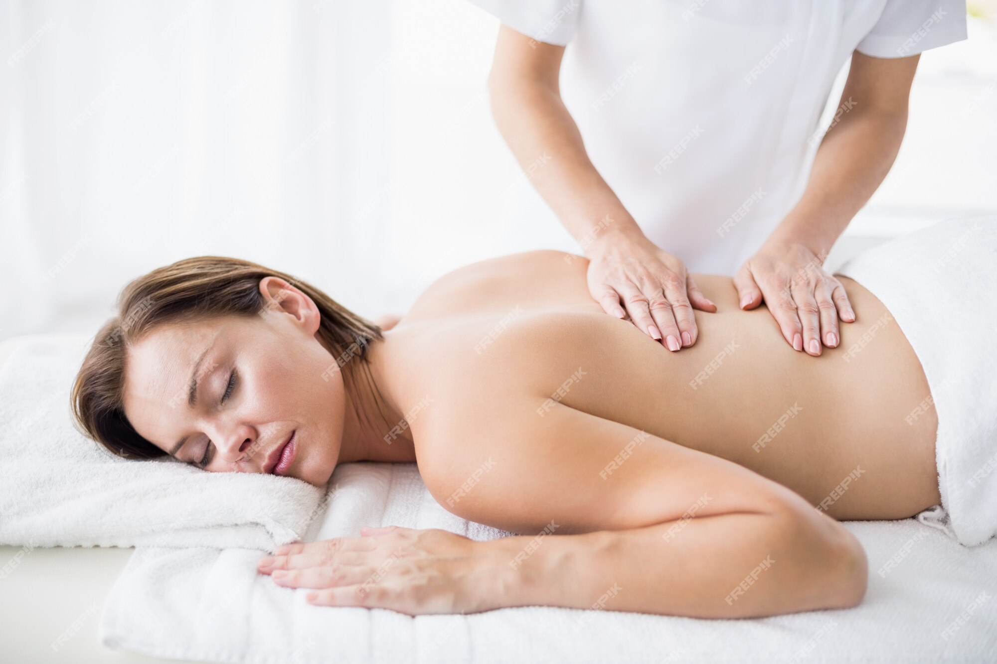 woman giving back massage to a girl Stock Photo